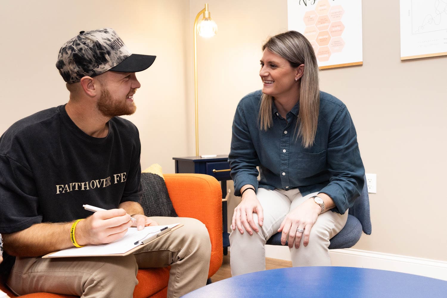 Taylor assisting a patient fill in a questionnaire to asses his health