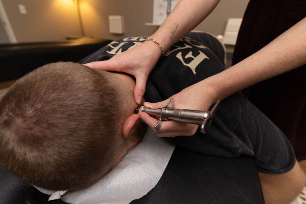 Dr. Tara performing a precise, gentle adjustment on the upper neck of a patient