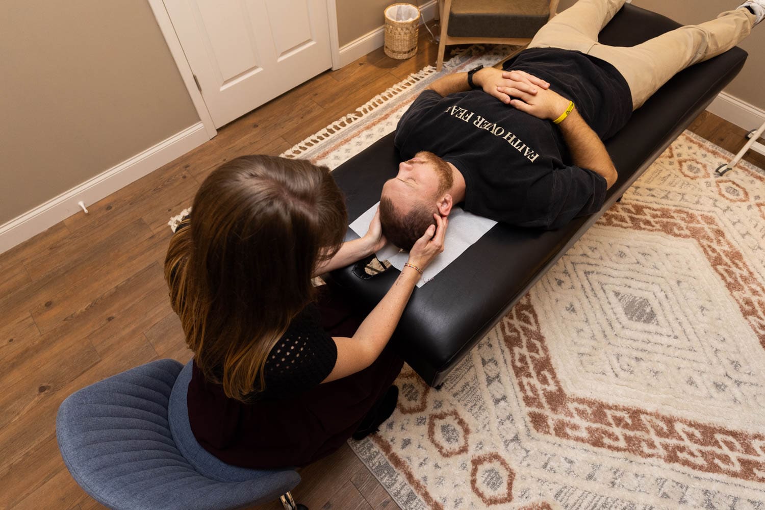 Dr. Tara performing light-touch cranial chiropractic work on a male patient